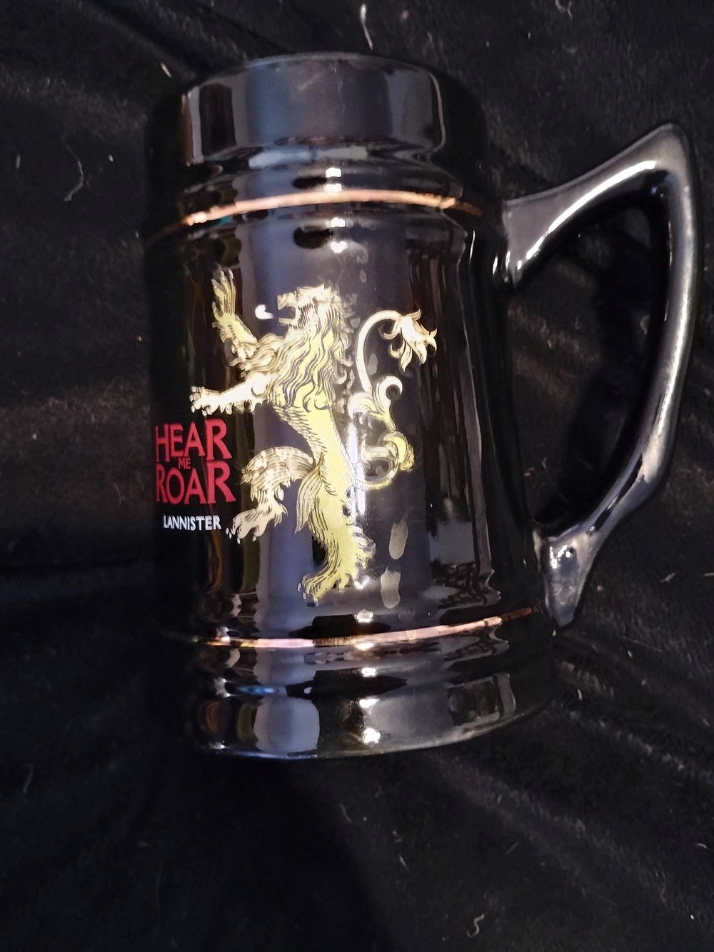 Black Ceramic Mug with Gold Lion Crest and Red Accent
